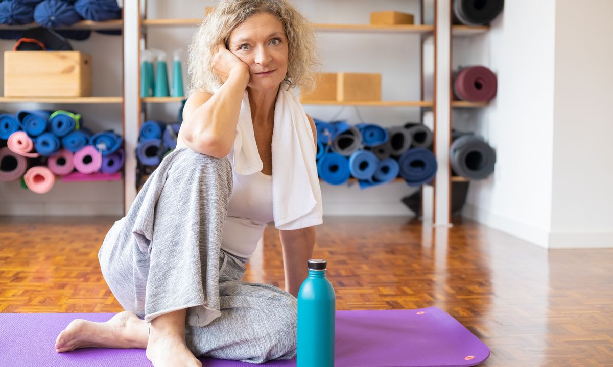 A mature woman exercising on a yoga mat