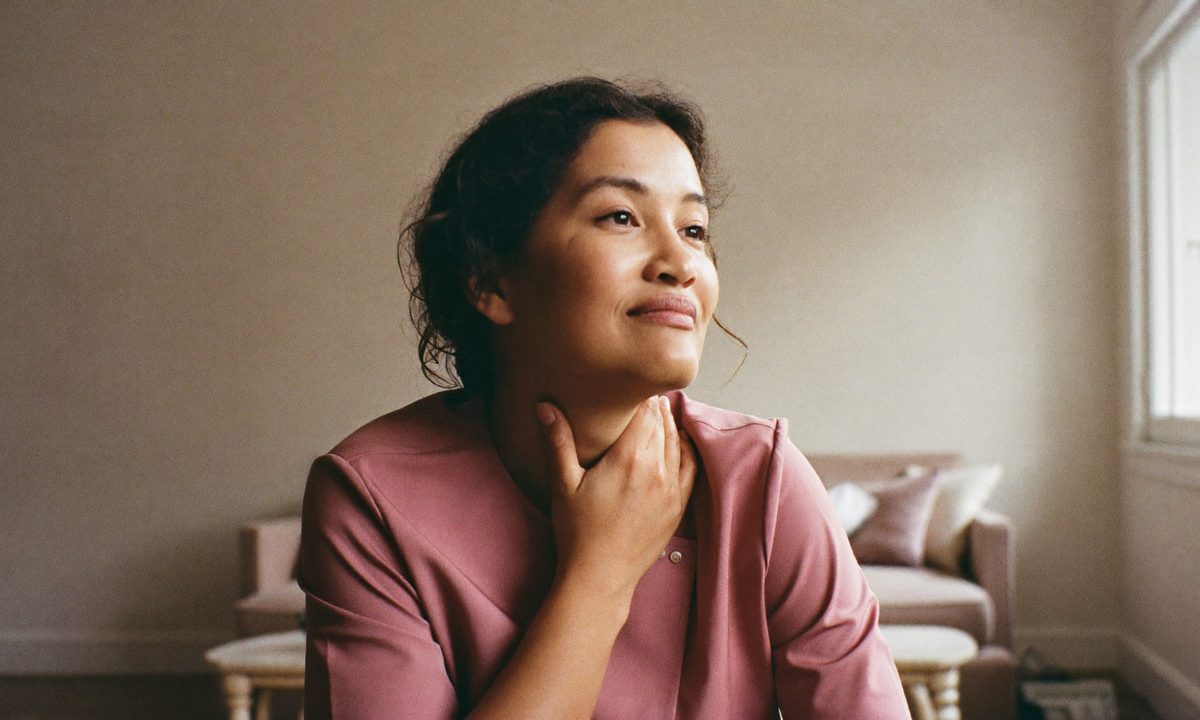 A woman in conversation with her doctor in a warmly lit consulting room